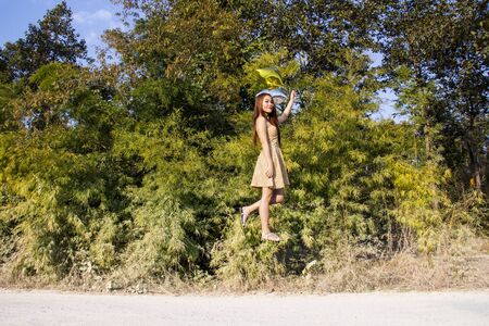 Asian girl floating with balloonsの写真素材