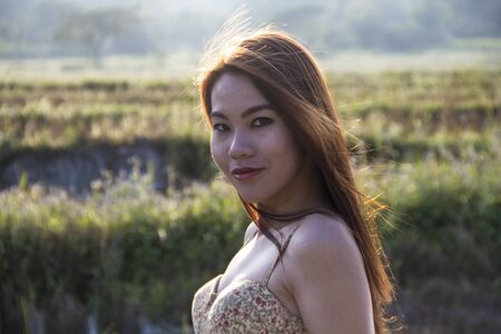 Asian girl standing in a fieldの写真素材