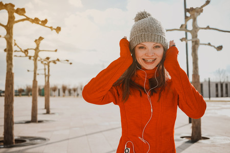 Happy sports girl on the street in park, early morningの写真素材