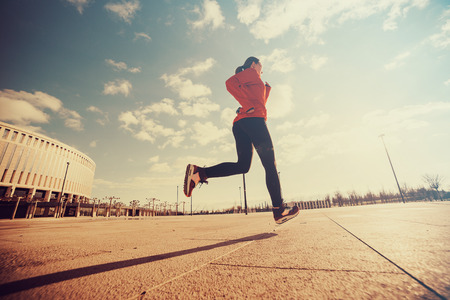 Early morning sunrise rays and running woman