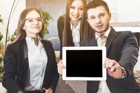 Business meeting coworkers shows mock up template blank tablet pc it hands with proud confident smile on backgroundの写真素材