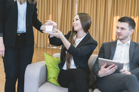 secretary brought a cup of coffee for business meetingの写真素材