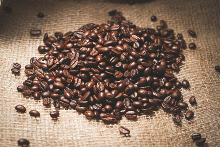 A bunch of coffee beans lies on a sacking