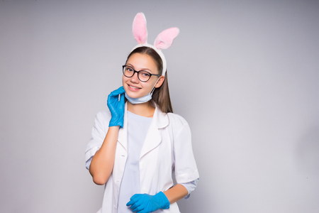 A cute female student doctor takes a mask and smilesの写真素材