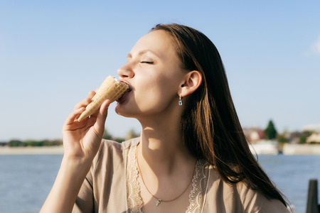 young girl enjoys ice creamの写真素材