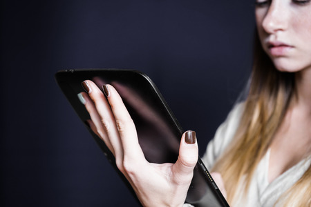 A teenager is looking for something in a tablet computerの写真素材