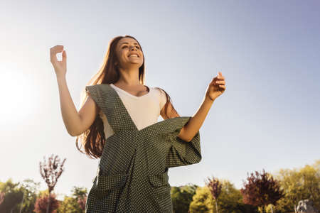 Free Happy Woman Enjoying Nature. Beauty Girl Outdoor. Freedom concept. Beauty Girl over Sky and Sun. Sunbeams. Enjoymentの写真素材