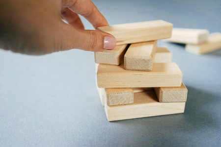 The hand holds a wood briquettes board gameの写真素材