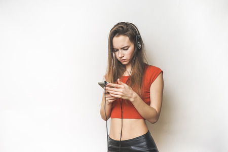 Woman in headphones,selfie on mobile,looking somethingの写真素材