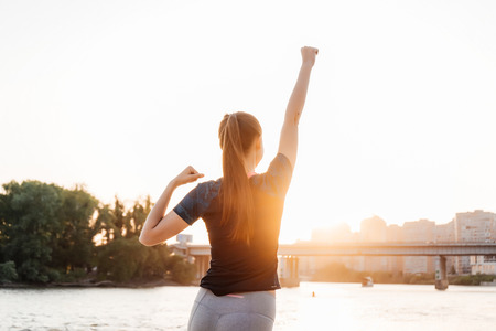 The girl throws up her hand with joy, victory, winnings, success. Victory in sports competitions