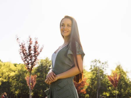 happy girl with long hair on nature background smilingの写真素材