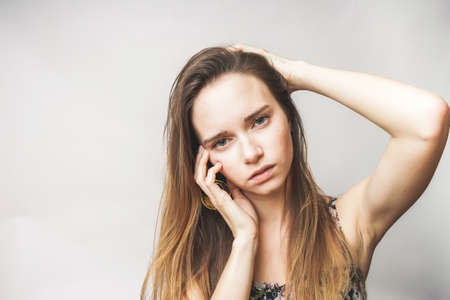 Tired posing young girl with long hairの写真素材