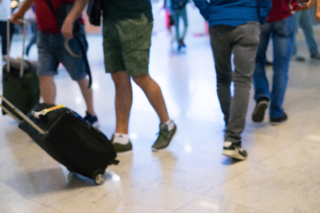 Abstract background feet people in airport with luggageの写真素材