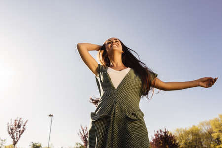 Free Happy Woman Enjoying Nature. Beauty Girl Outdoor. Freedom concept. Beauty Girl over Sky and Sun. Sunbeams. Enjoyment.の写真素材