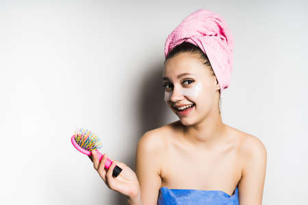 smiling girl after shower, isolated, on white background, blue towelの写真素材