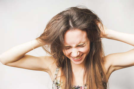 Funny woman touch hairs on a white background