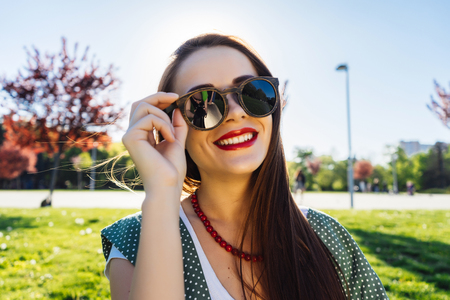 Portrait of Happy Fashion Woman in Sunglasses. Smiling Trendy Girl in Summer.の写真素材