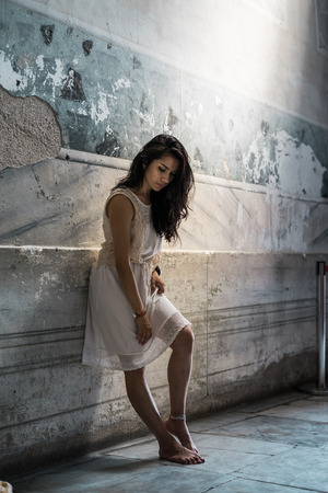 Portrait of a girl barefoot in the interior of a templeの写真素材