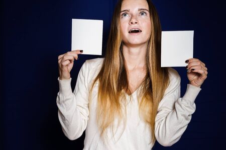 the girl is surprised to hold two small sheetsの写真素材