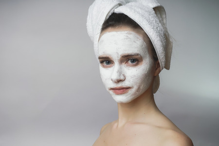 Woman enjoying white spa mack,scrub on face.Clean skinの写真素材
