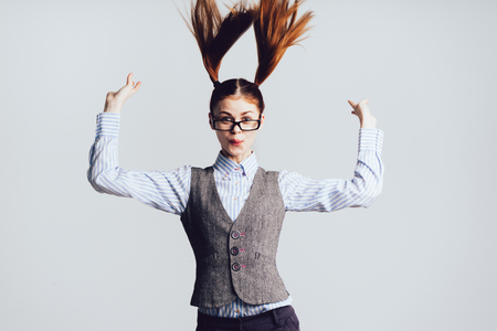 cute girl with two tails on her head bouncingの写真素材