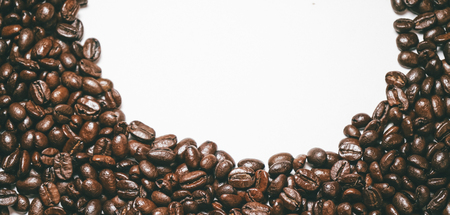 on a white surface beautifully scattered grains of fragrant coffee