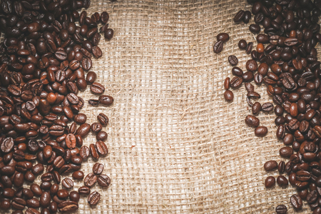 on coarse beige fabric lie aromatic coffee beansの写真素材