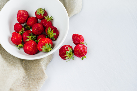 Fresh raw healthy diet strawberries fruit in plate,isolated on white,view above,flatlay close-up,copyspace for text,frame.Village rustic  canvas,countryside foodの写真素材