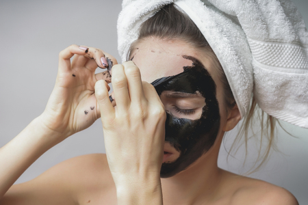 Woman remove black mask,good results. Face scrub,exfoliation pores,clean skinの写真素材