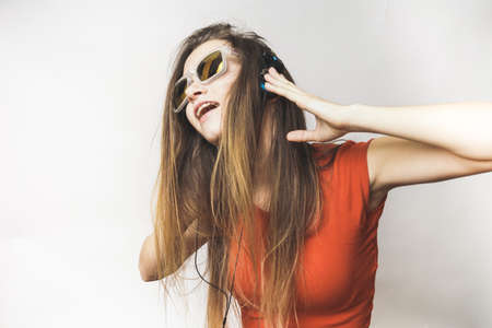 Young Teenage with headphones. long-haired girl in sunglasses dancingの写真素材