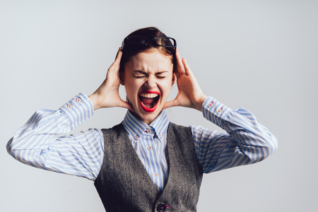 Young girl student cries from anger on a white backgroundの写真素材
