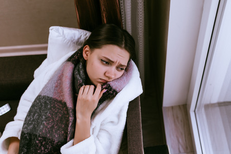 sad girl got sick before the new year, sore throat due to cold weather,の写真素材