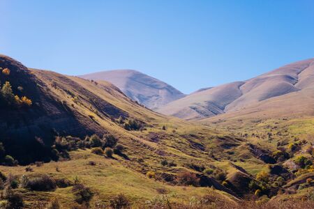 inspiring nature, Caucasian mountains covered with grass, blue skyの写真素材