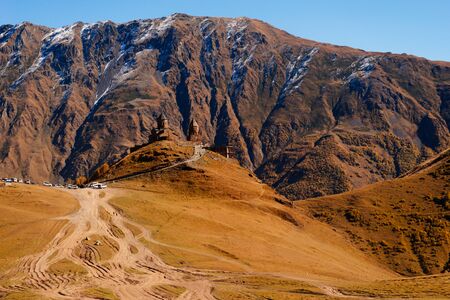 magnificent nature, yellow field, high mountains against the blue skyの写真素材