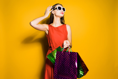 stylish confident girl in sunglasses went shopping on a sale