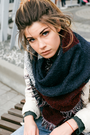 young beautiful girl in stylish scarf walking outdoors, cold weatherの写真素材