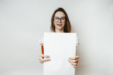Woman shows a4 blank on a white backgroundの写真素材