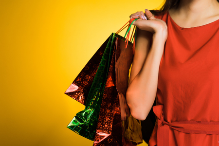fashionable girl in a red dress has bought many gifts for the new yearの写真素材