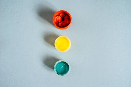 on a blue table are jars with a colorful gouacheの写真素材