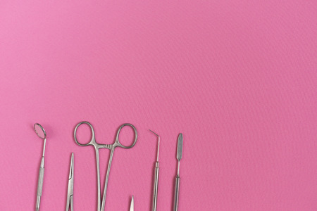 on the pink surface are medical dental instrumentsの写真素材