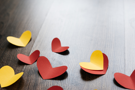 Valentine 's Day background, red and yellow hearts on wood textureの写真素材