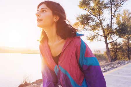 beautiful young woman on a lake background