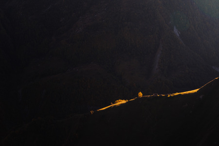 sunset against the backdrop of high mountainsの写真素材