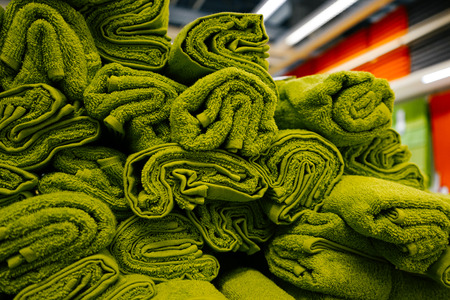 in the store are a lot of green bath towelsの写真素材