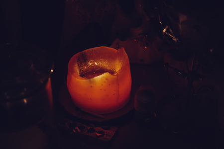 the candle lies on the table next to the tabletsの写真素材