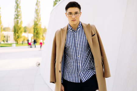 stylish guy in glasses posing on white backgroundの写真素材