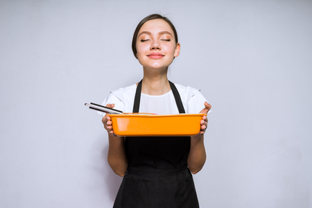 cute young woman chef in black apron cooked a delicious pieの写真素材