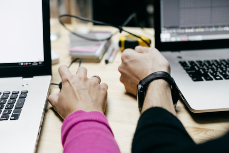 office workers, graphic designers are working on a project on laptops togetherの写真素材