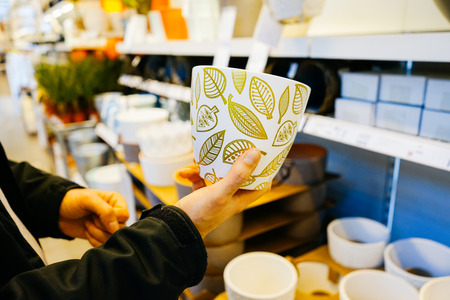a woman chooses her own dishes in the store
