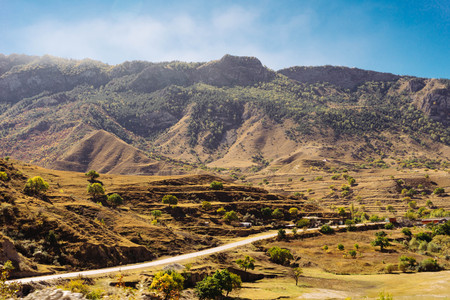 road against the background of the high beautiful mountainsの写真素材